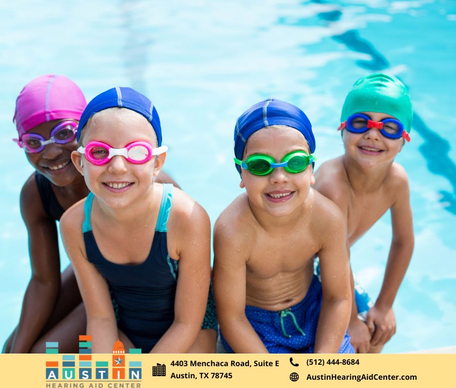 Kids with big smiles in the swimming pool